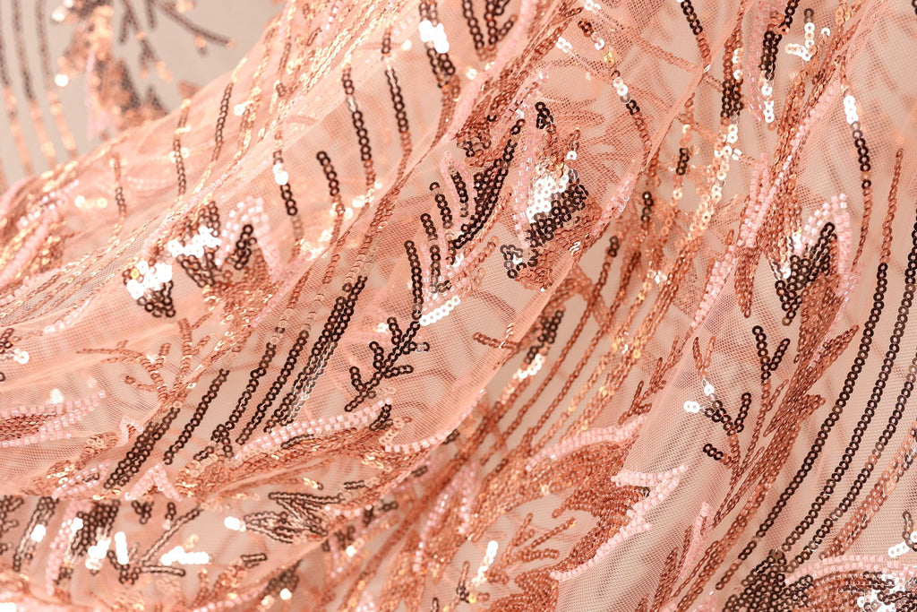 The image is a close-up of a fabric with a floral pattern, featuring a mix of pink and black sequins.