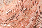 The image is a close-up of a fabric with a floral pattern, featuring a mix of pink and black sequins.