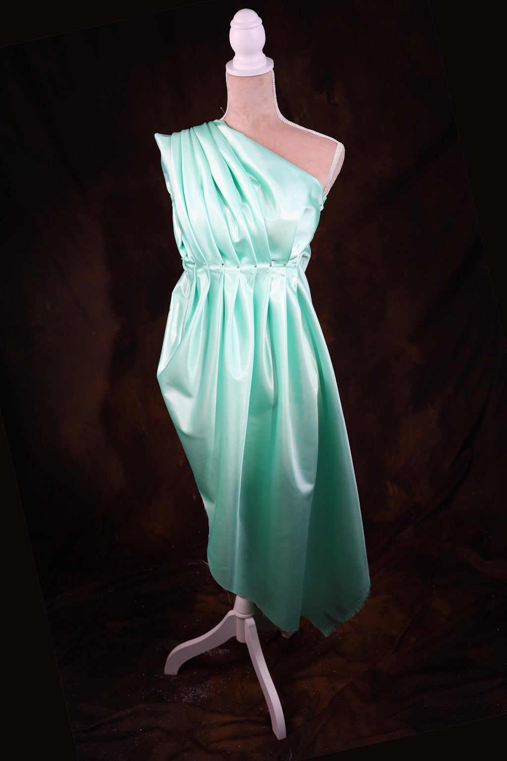 a dress on a mannequin on a black background