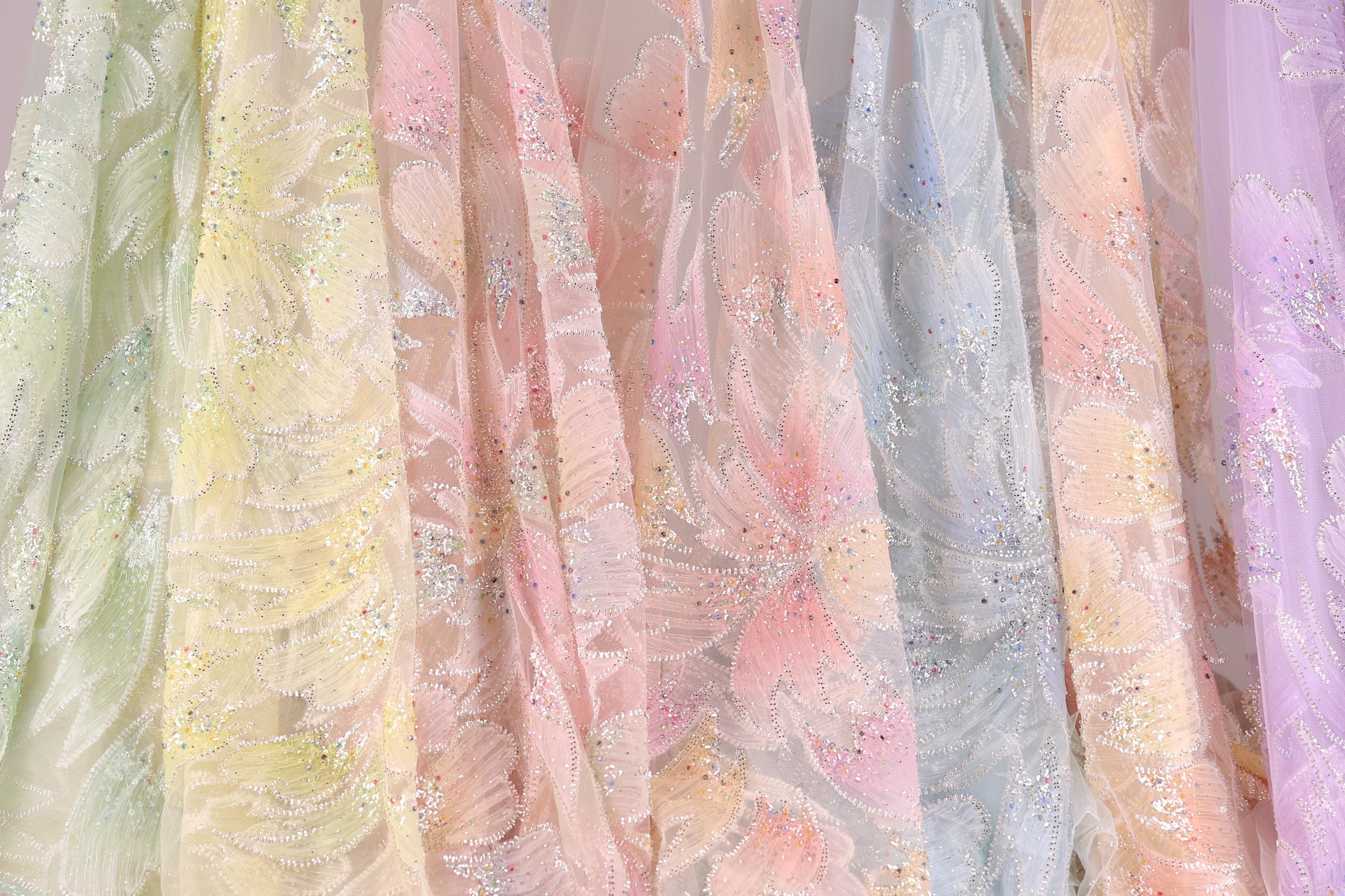a variety of colorful, patterned fabric swatches, showcasing different textures and designs.