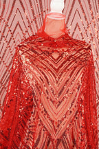 a red sequin fabric with a geometric pattern, creating a visually striking and eye-catching design.