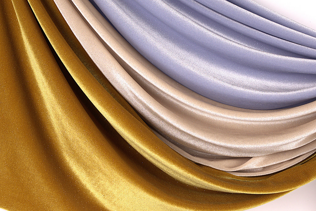 a close-up view of a fabric with a shiny, metallic texture in gold, silver, and blue colors.