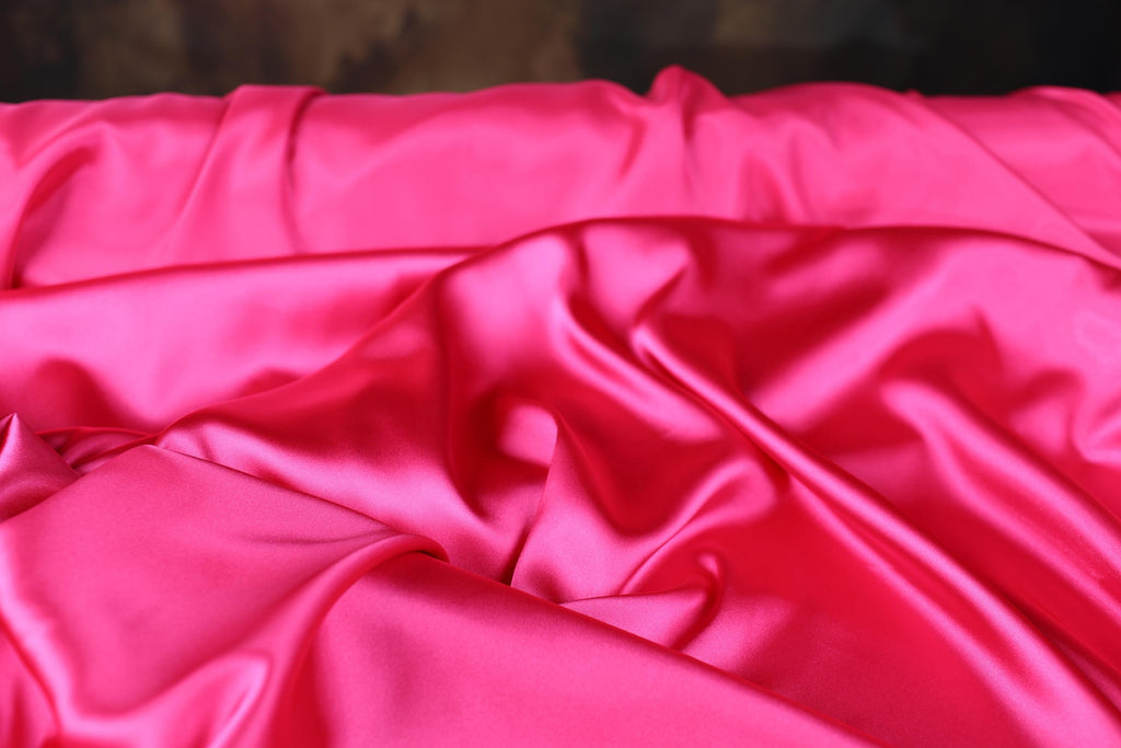 a close up of a pink satin material