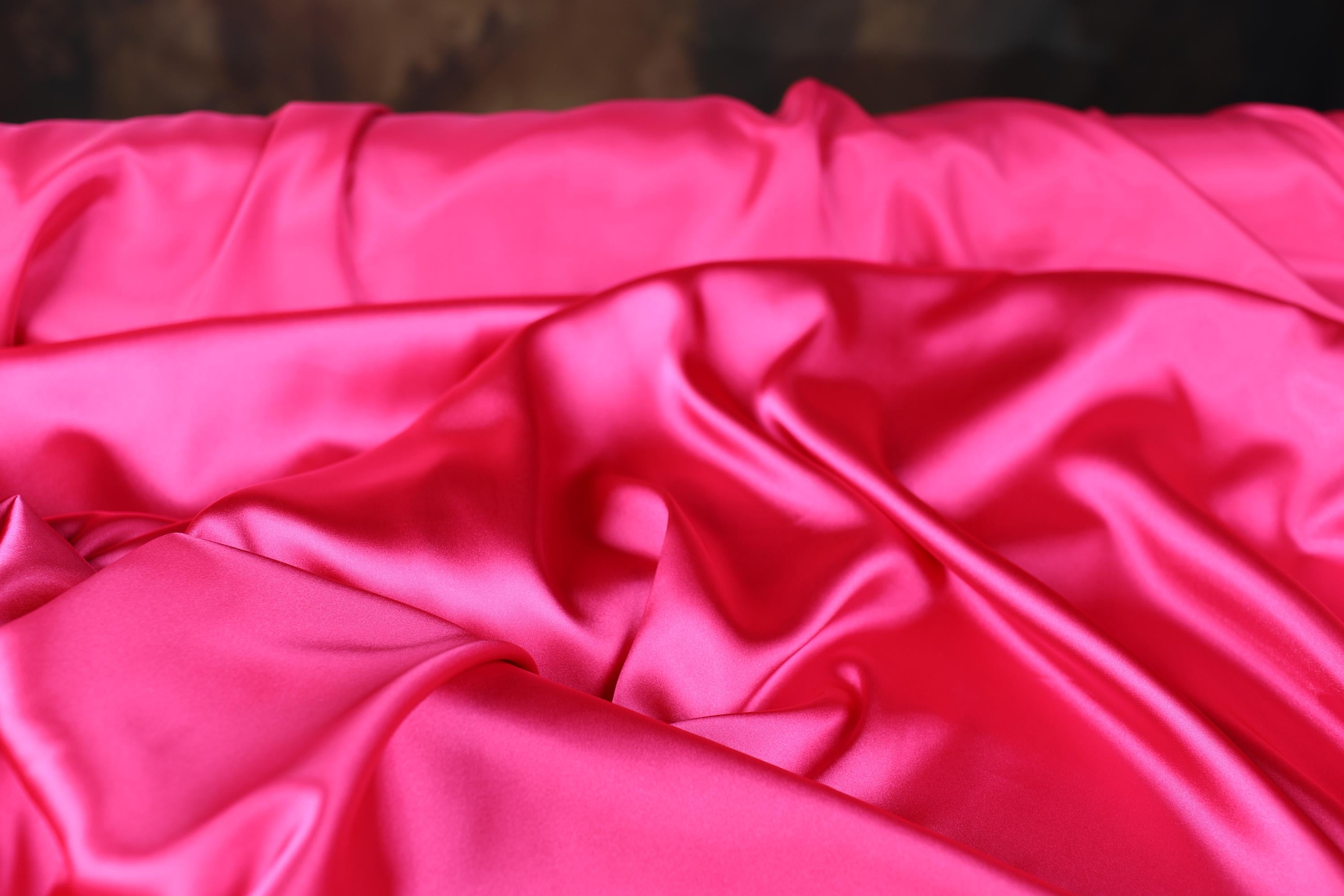 a close up of a pink satin material