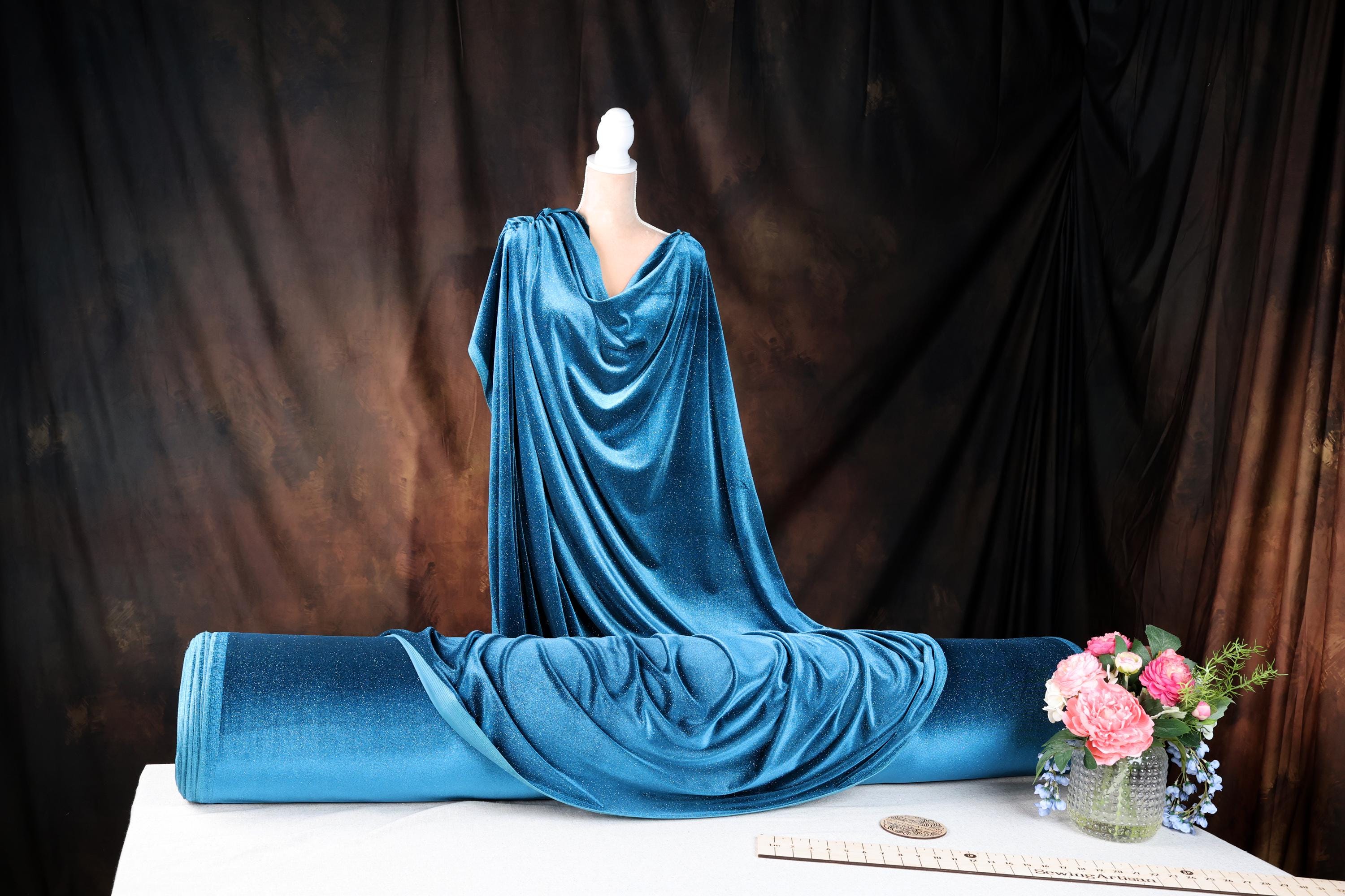 a dress on a mannequin with a vase of flowers
