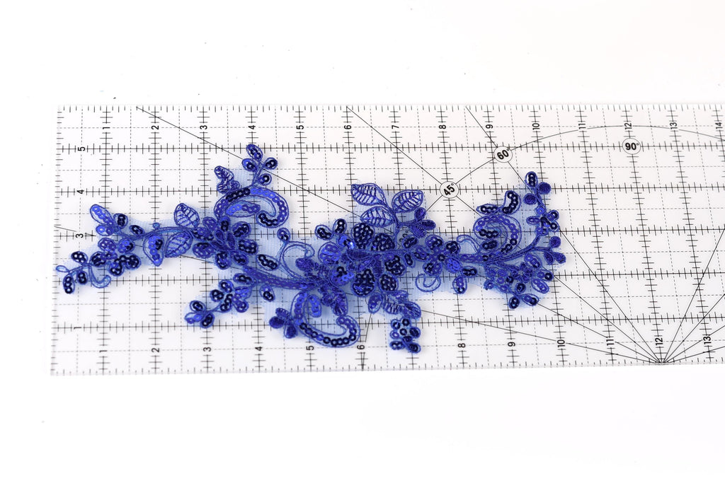 a close-up view of a blue lace-like fabric with intricate floral patterns.