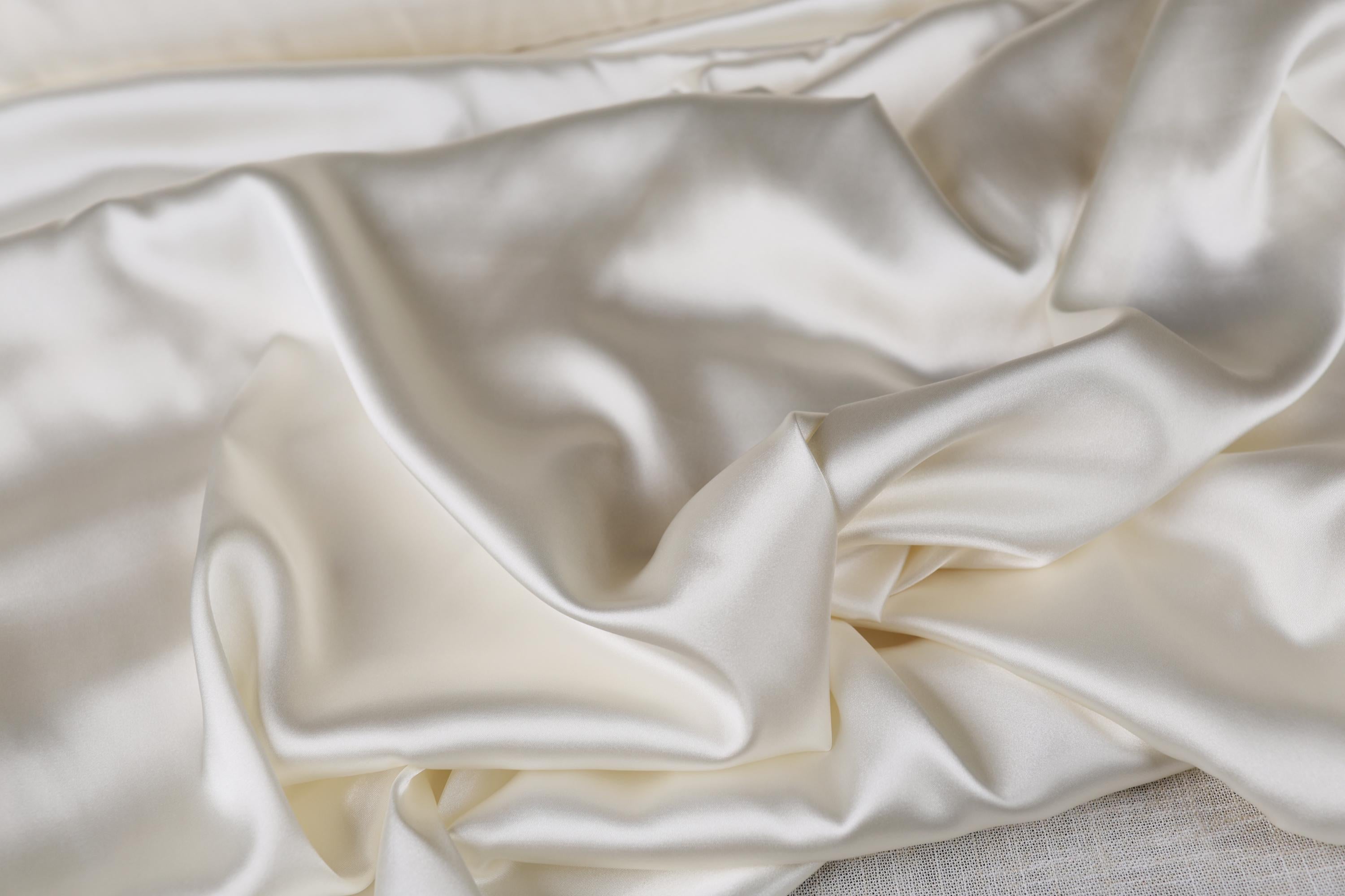 a close up of a white satin fabric