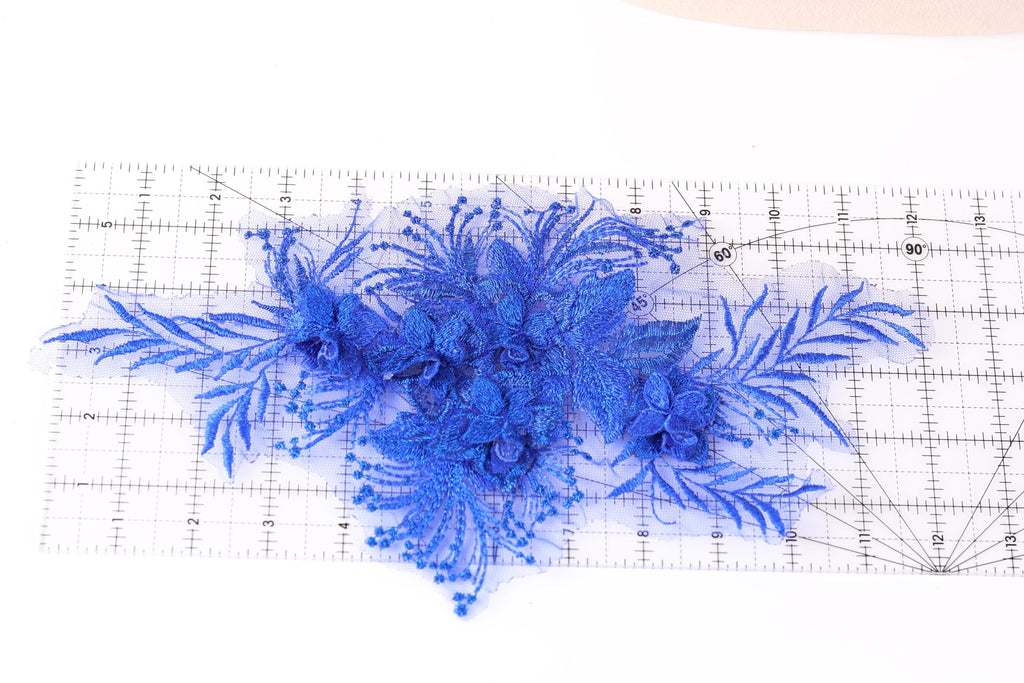 a close-up view of a blue floral lace piece, with its intricate details and vibrant color.