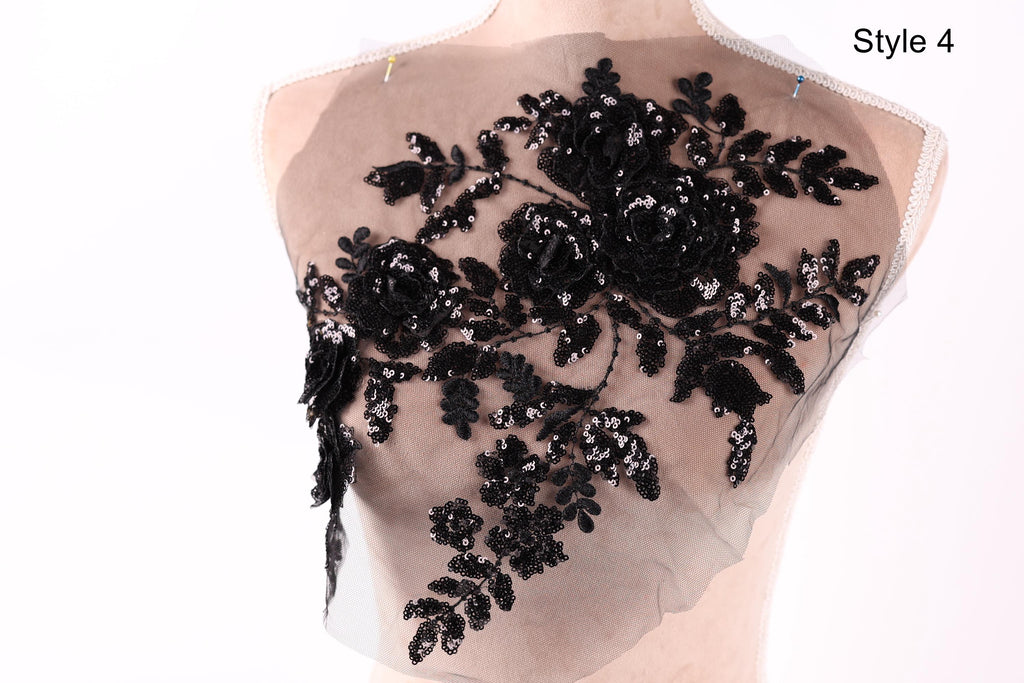 A mannequin with a black lace or sequin floral pattern on its bust area.