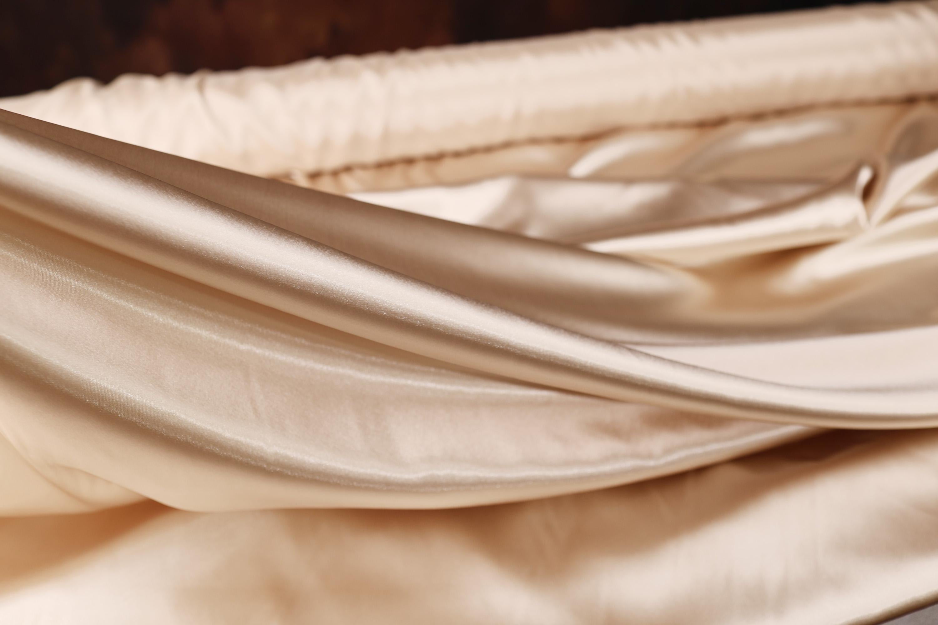 a close up of a folded sheet on a bed