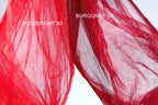 two pieces of red fabric, one appearing to be a bright red color and the other a more muted red color, possibly burgundy. The bright red fabric is labeled "REDBRIGHT 90" and the more muted red fabric is labeled "BURGUNDY 32".