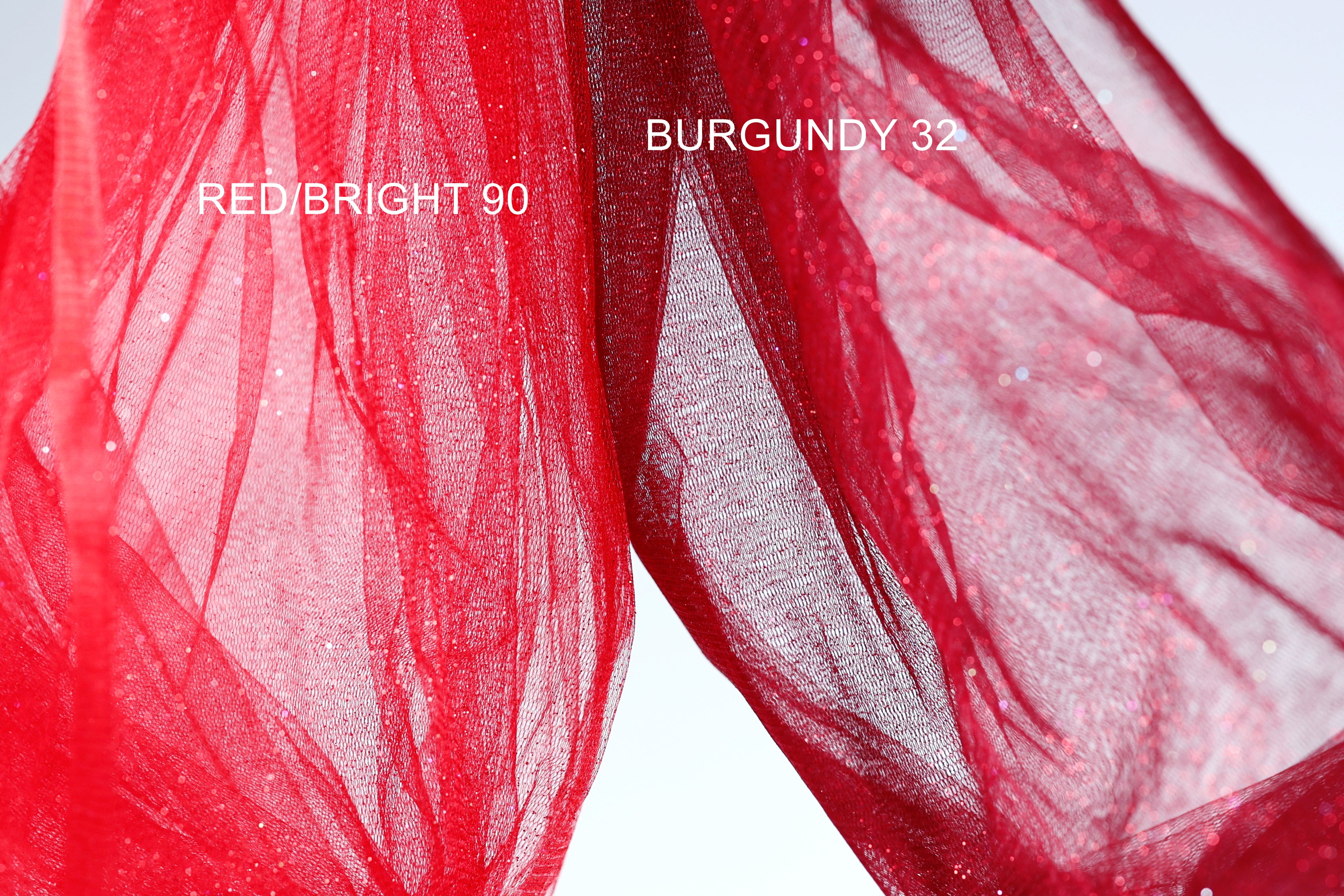 two pieces of red fabric, one appearing to be a bright red color and the other a more muted red color, possibly burgundy. The bright red fabric is labeled "REDBRIGHT 90" and the more muted red fabric is labeled "BURGUNDY 32".