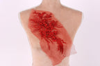 a mannequin torso with a red floral embroidered on it, set against a white background.