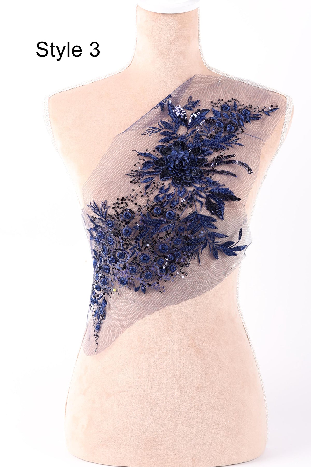A mannequin wearing a dress with a floral pattern on the shoulder area.