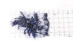 a close-up view of a blue, glittery, and intricate piece of fabric or material, possibly a decorative element or a textile.