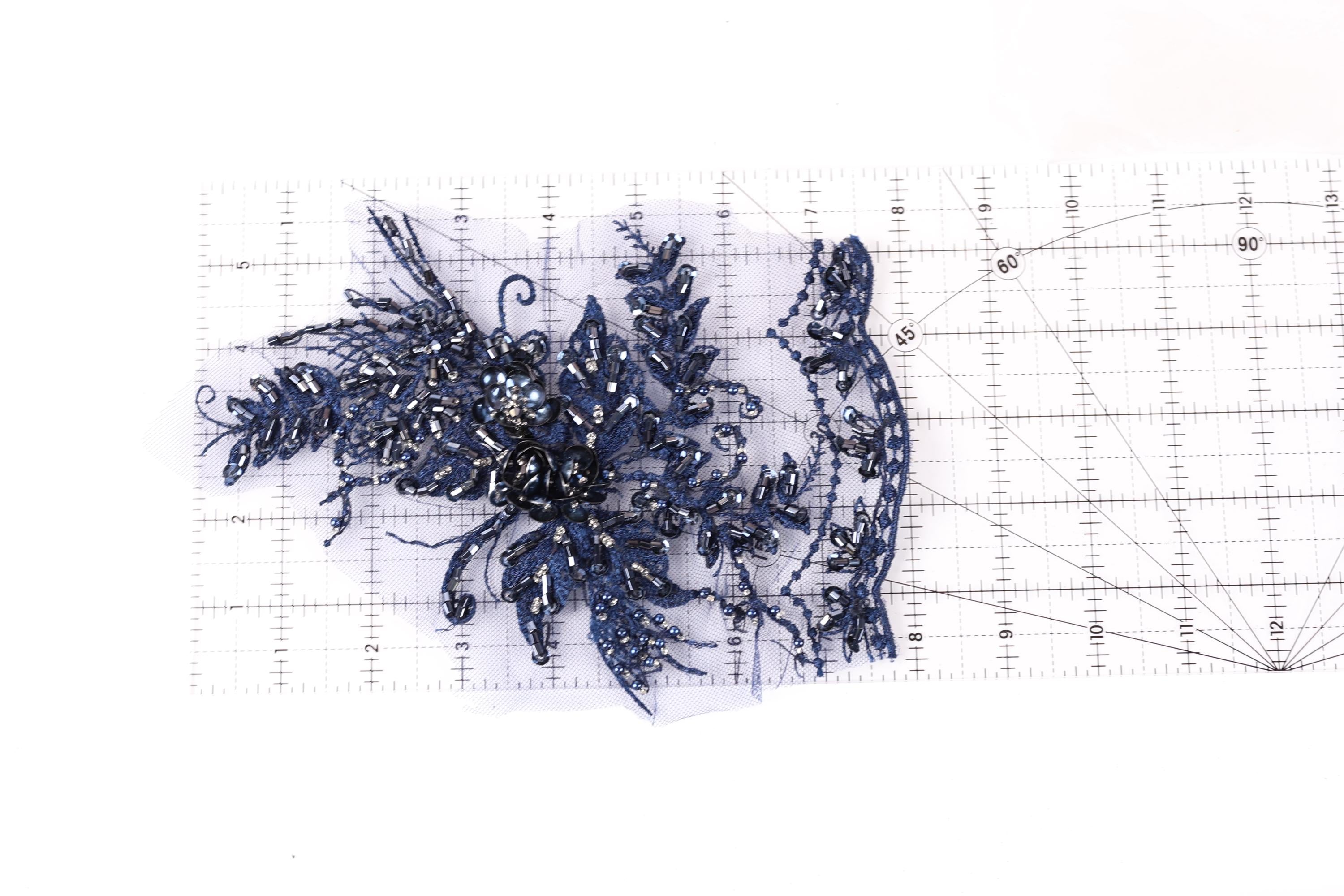 a close-up view of a blue, glittery, and intricate piece of fabric or material, possibly a decorative element or a textile.