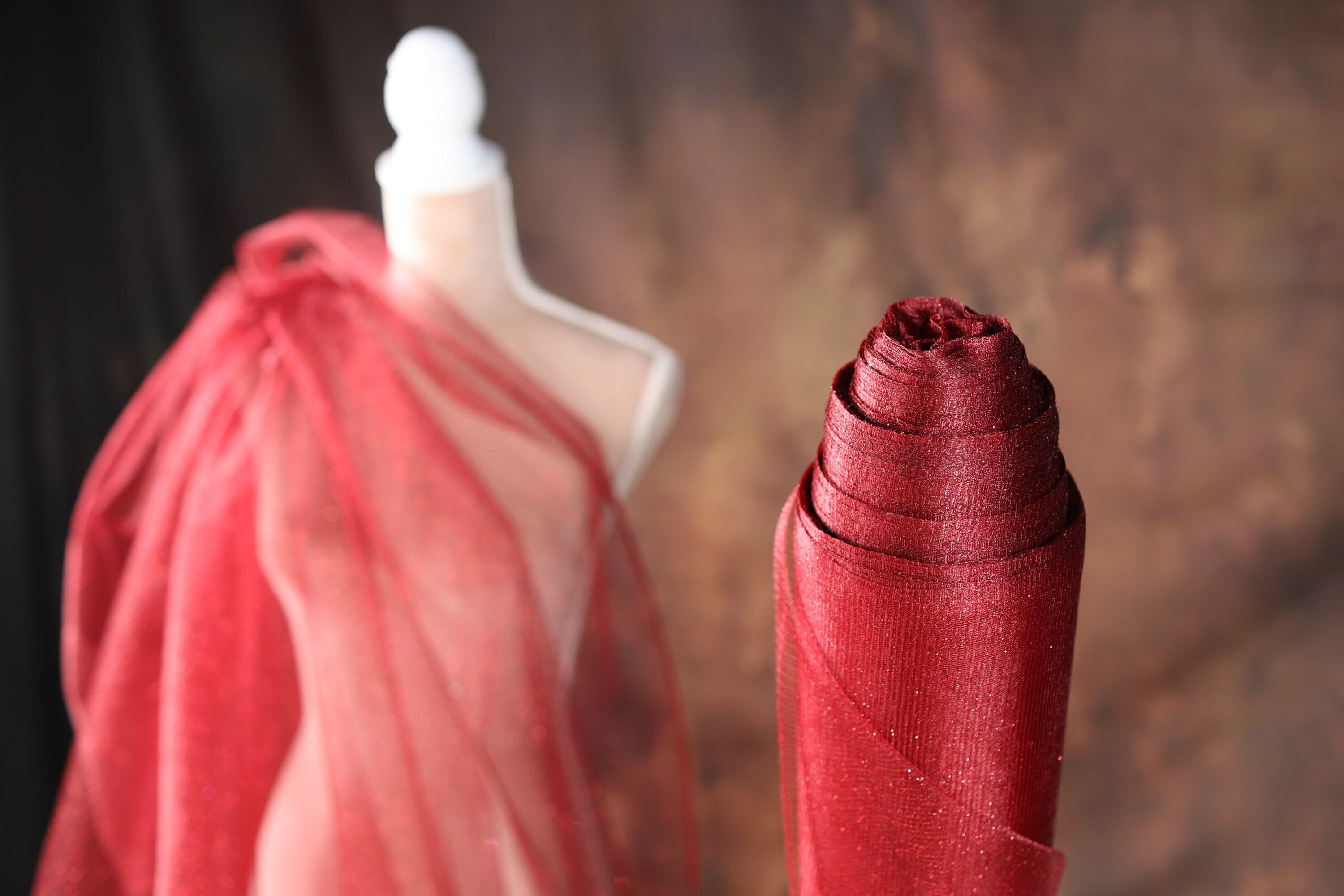a mannequin wearing a red veil and a red umbrella