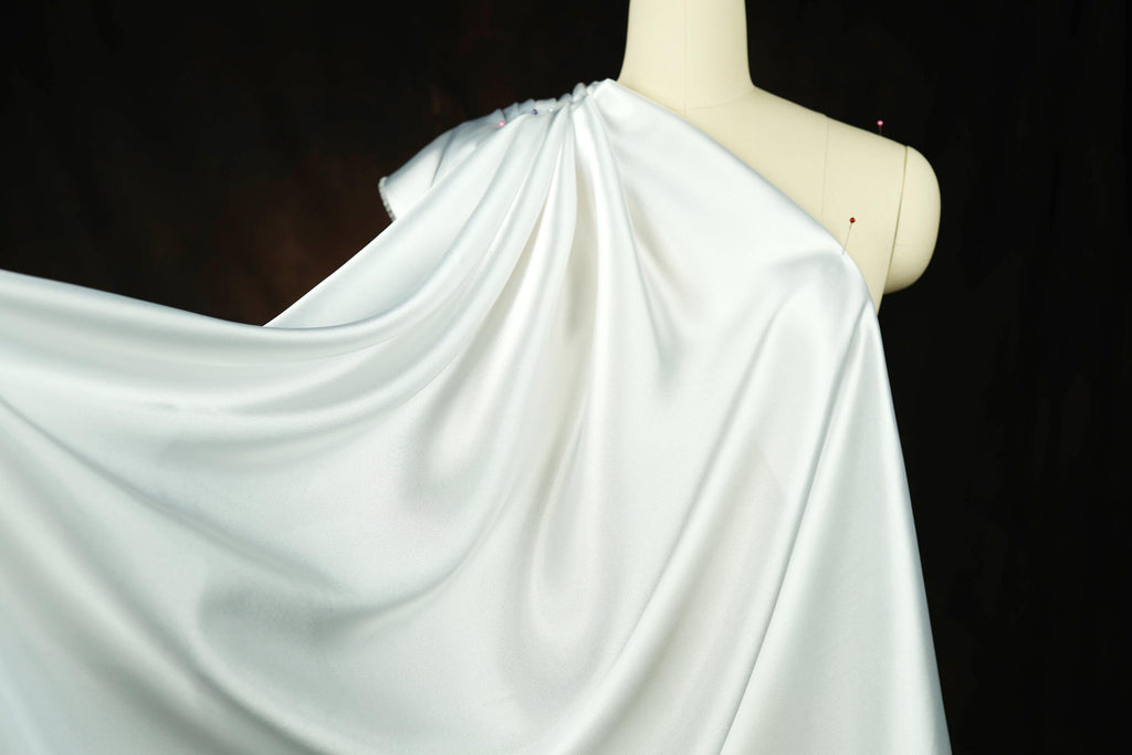 a mannequin with a white cloth draped over it