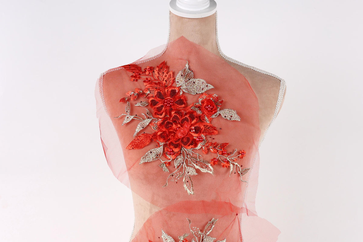 A mannequin wearing a red dress with a floral design on the back.