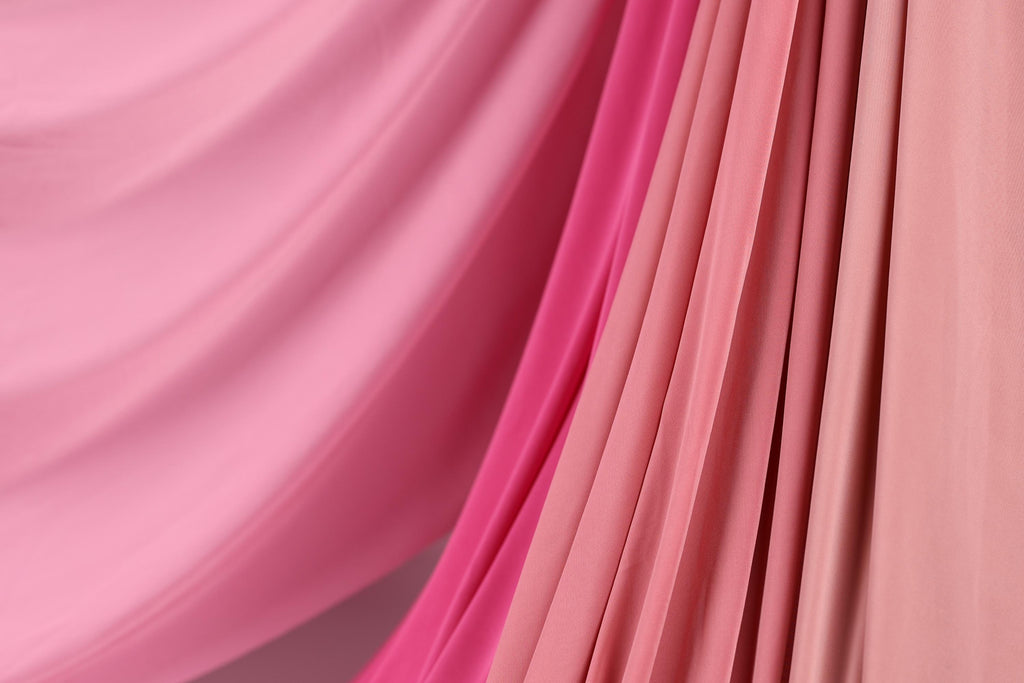 a close-up view of a fabric with a pink and red color gradient, creating a visually appealing and textured appearance.