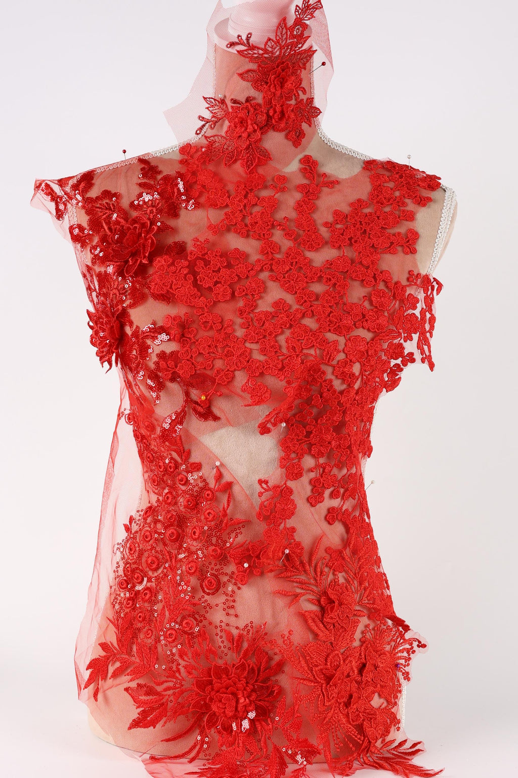 a red lace dress with intricate floral patterns and designs.