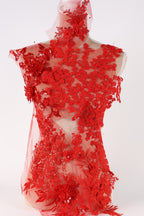 a red lace dress with intricate floral patterns and designs.