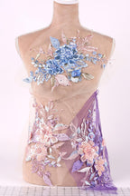 A mannequin torso wearing a dress with a floral pattern in shades of blue, pink, and purple.