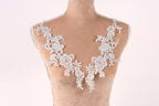 A mannequin with a delicate, lace-like design on its bust area, featuring intricate floral patterns.