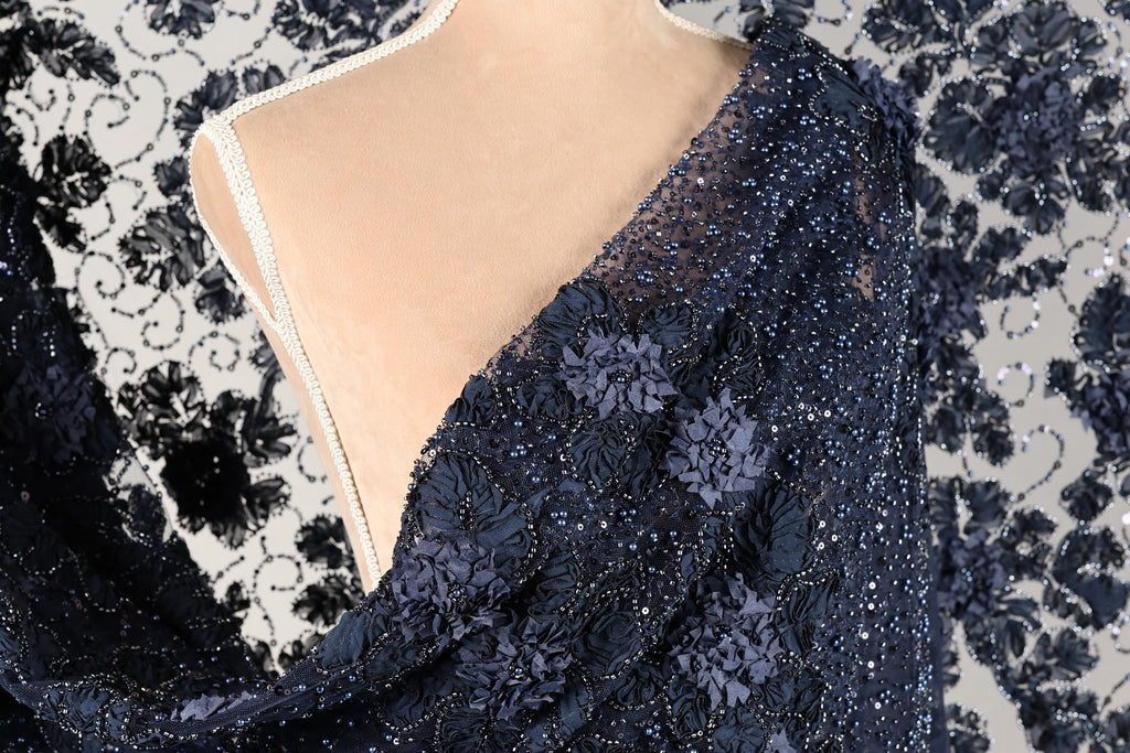 a close-up view of a mannequin wearing a blue dress with a floral pattern and sequins.