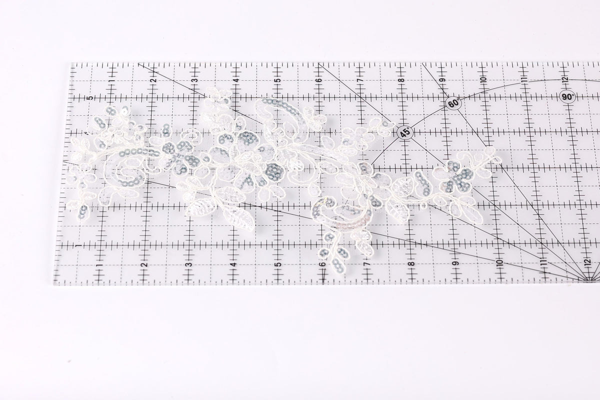 a clear ruler with a floral pattern on it, placed on a white surface.