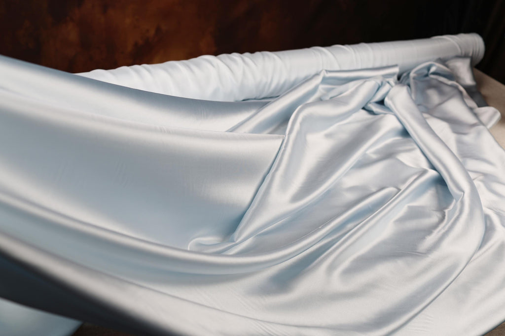 a close up of a bed with a sheet on it