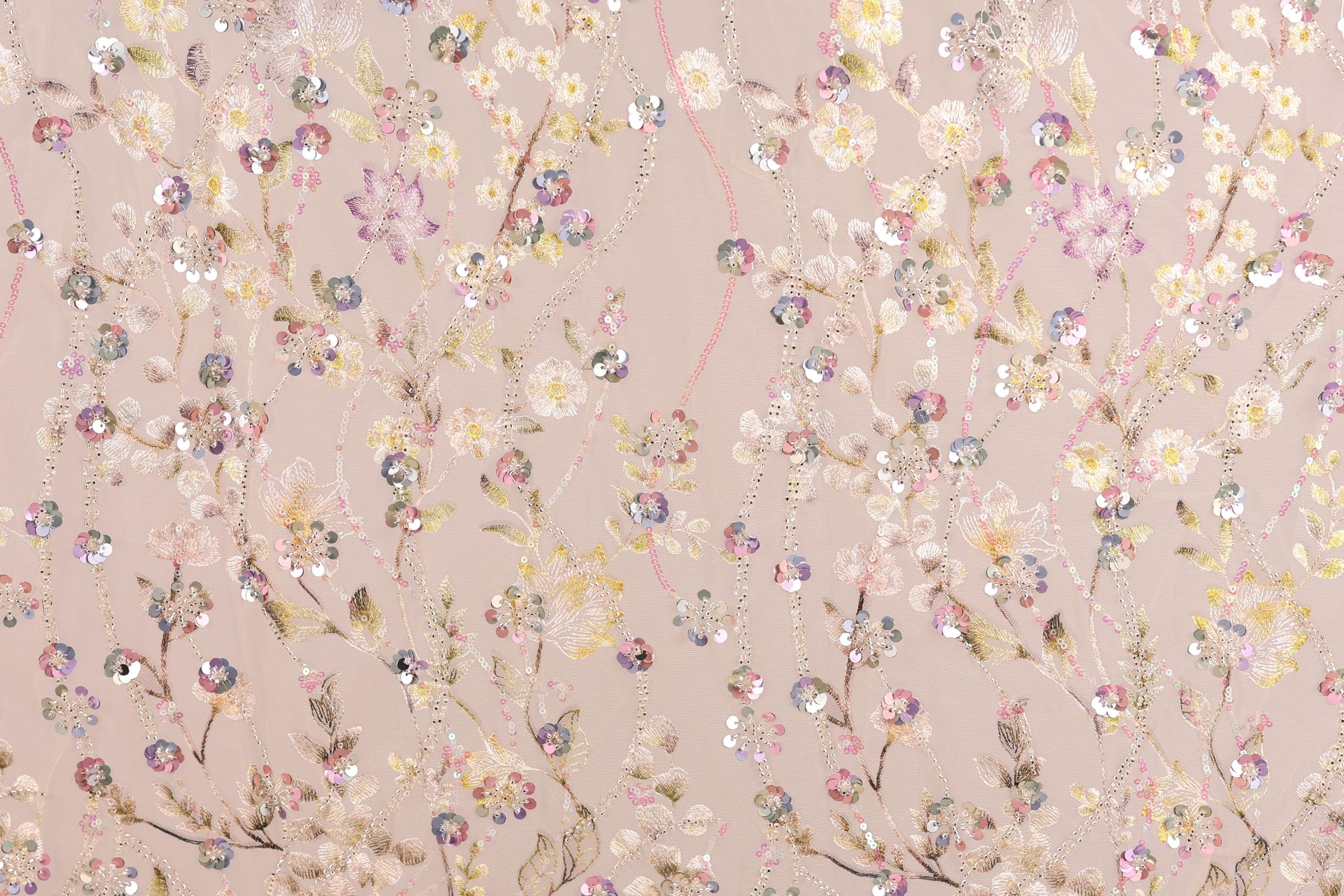 a pattern of pink and white flowers and leaves, with some embellished with sequins, creating a visually appealing and intricate design.