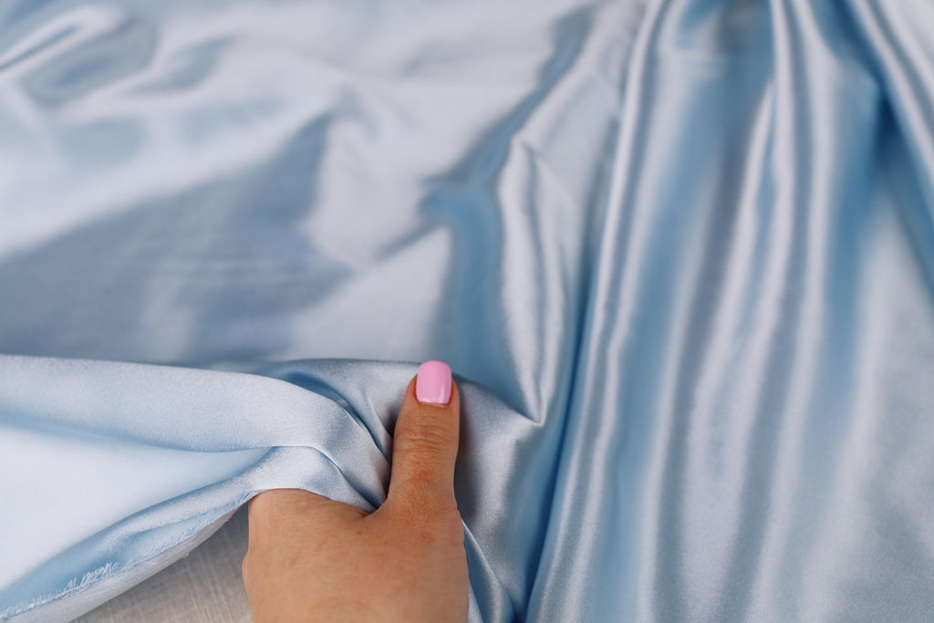 a person with a pink nail polish on their finger