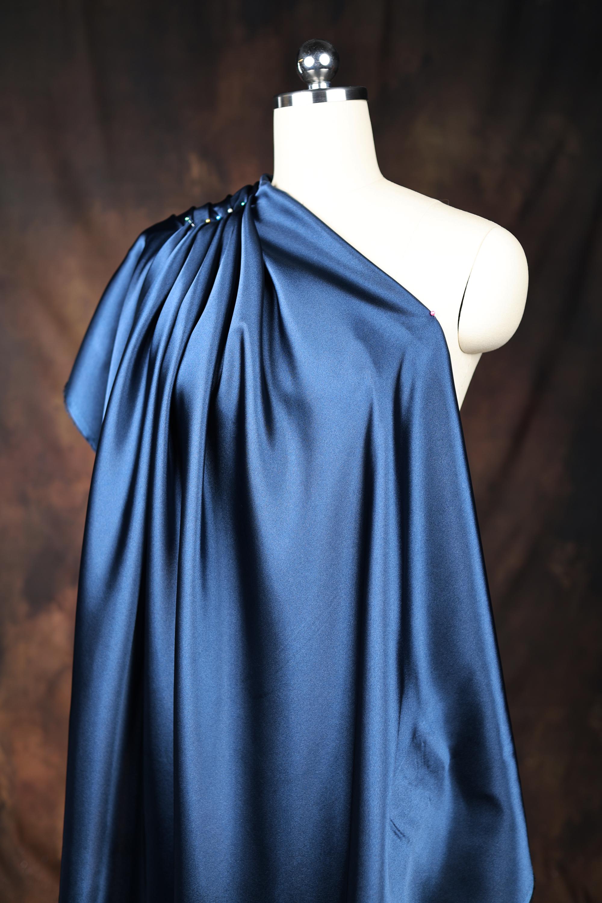 a white mannequin with a blue cape on top of it