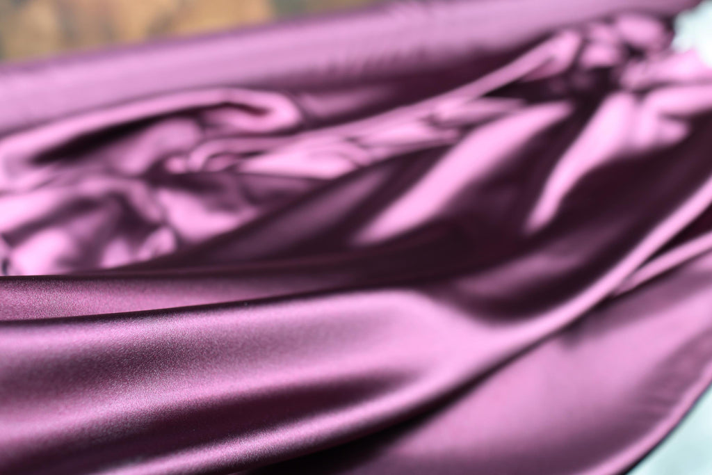 a close up of a purple satin material