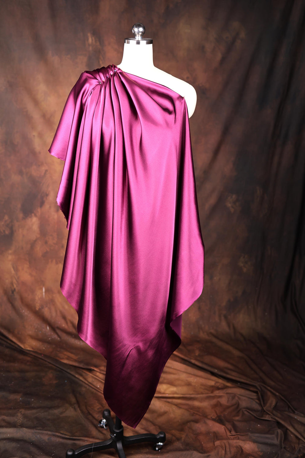 a mannequin dressed in a pink cape
