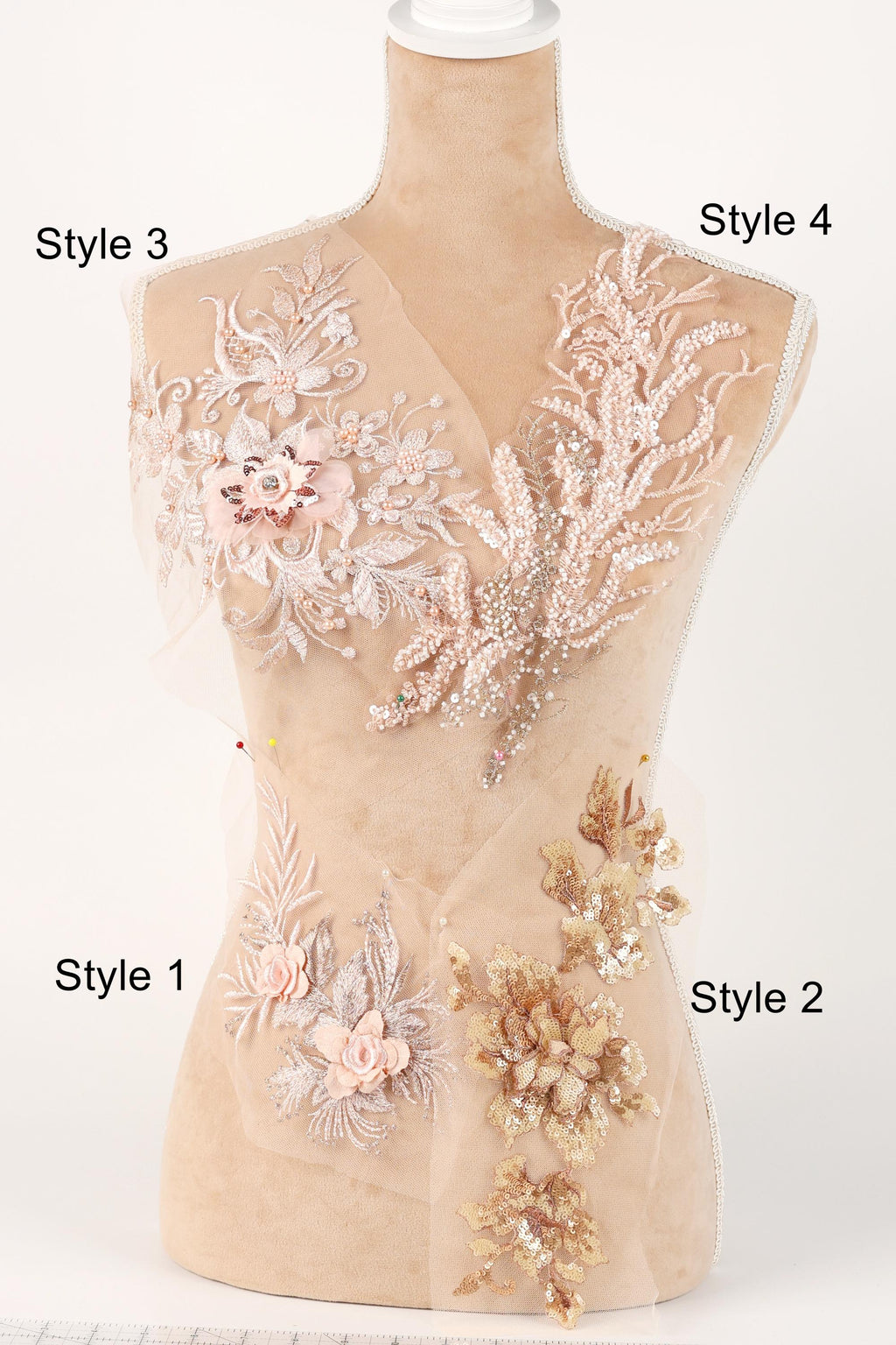 A mannequin with various decorative elements on its bust, including floral and leaf-like patterns in shades of pink and beige.