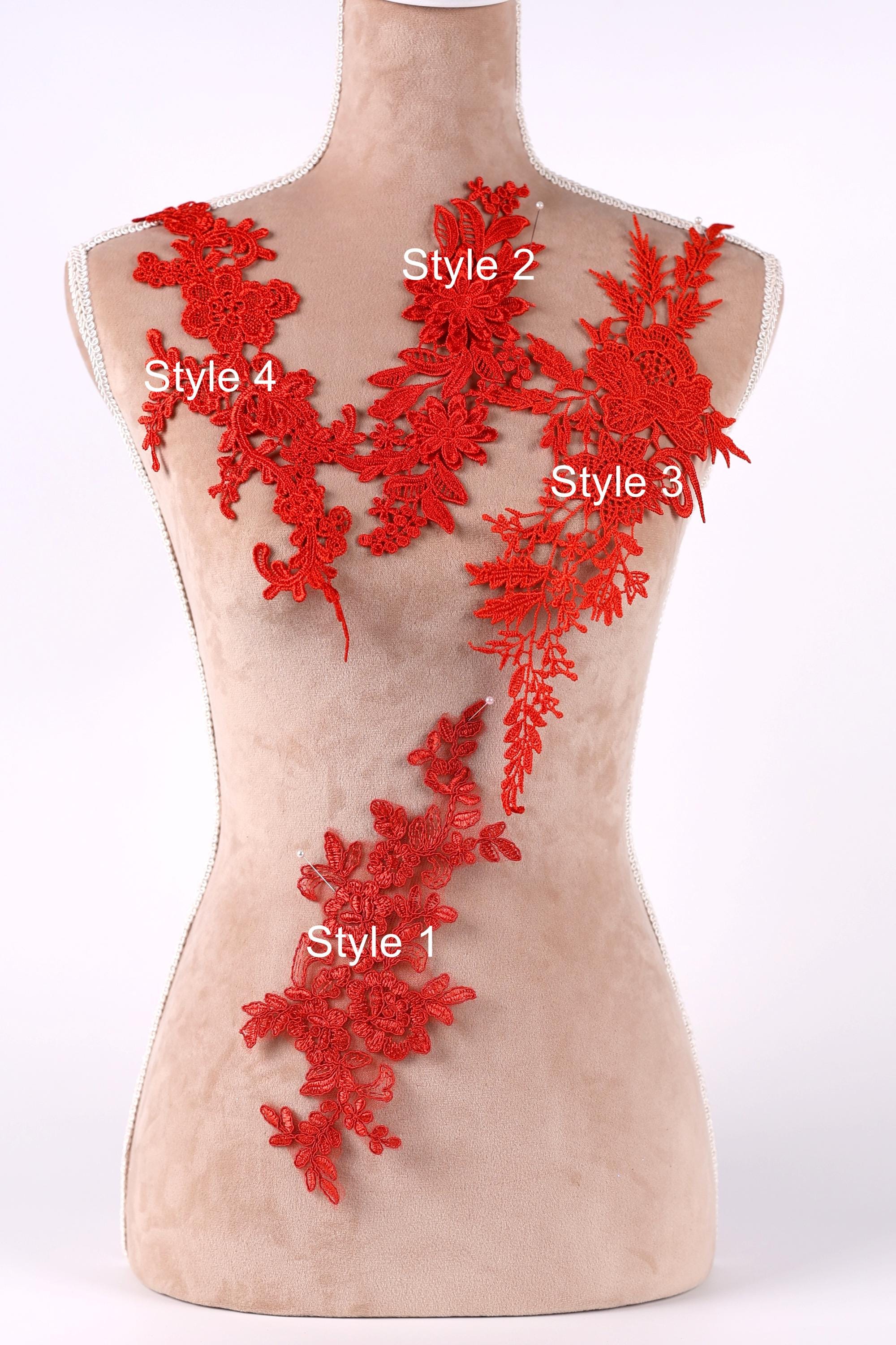 A mannequin with red floral embroidery on its bust area, each style labeled with a number.