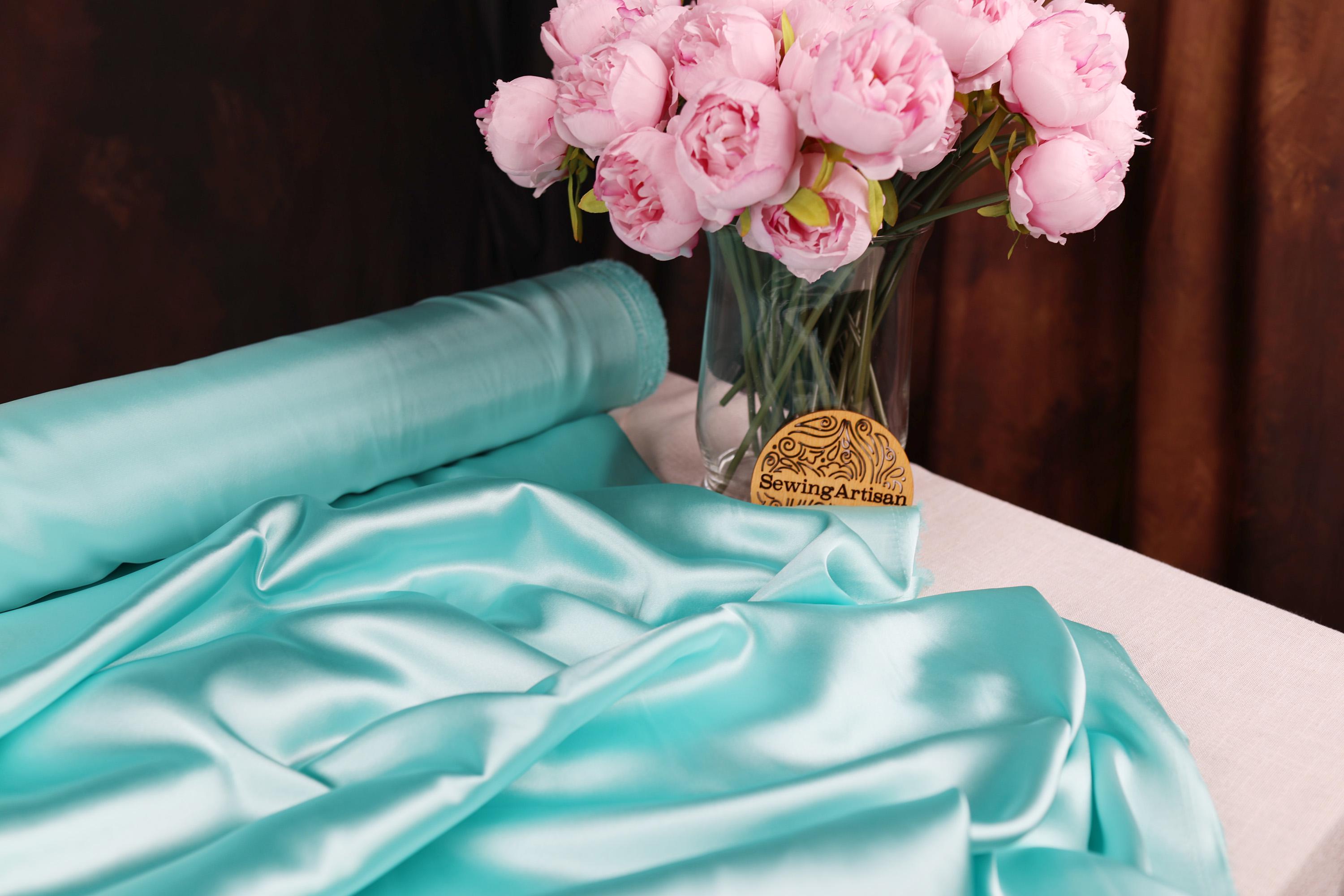 a vase filled with pink flowers on top of a table