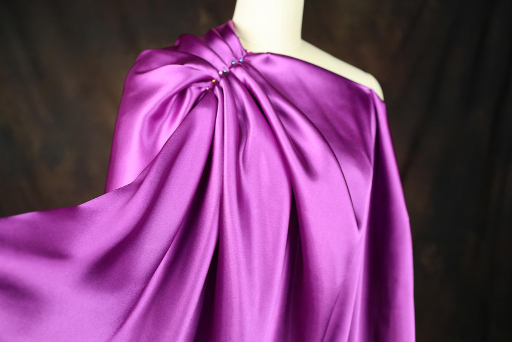 a mannequin is dressed in a purple dress
