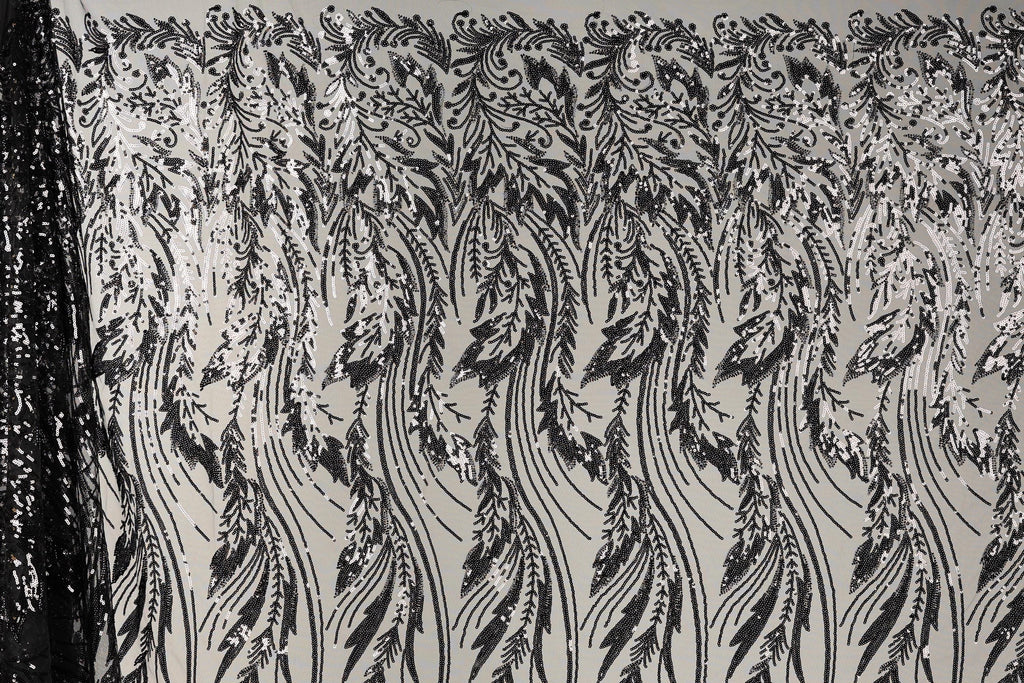 a close-up view of a black and white patterned fabric with a repeating floral design. The pattern consists of long, thin lines that create a sense of movement and rhythm across the fabric. The design is intricate and detailed, with each line contributing to the overall visual impact of the pattern.