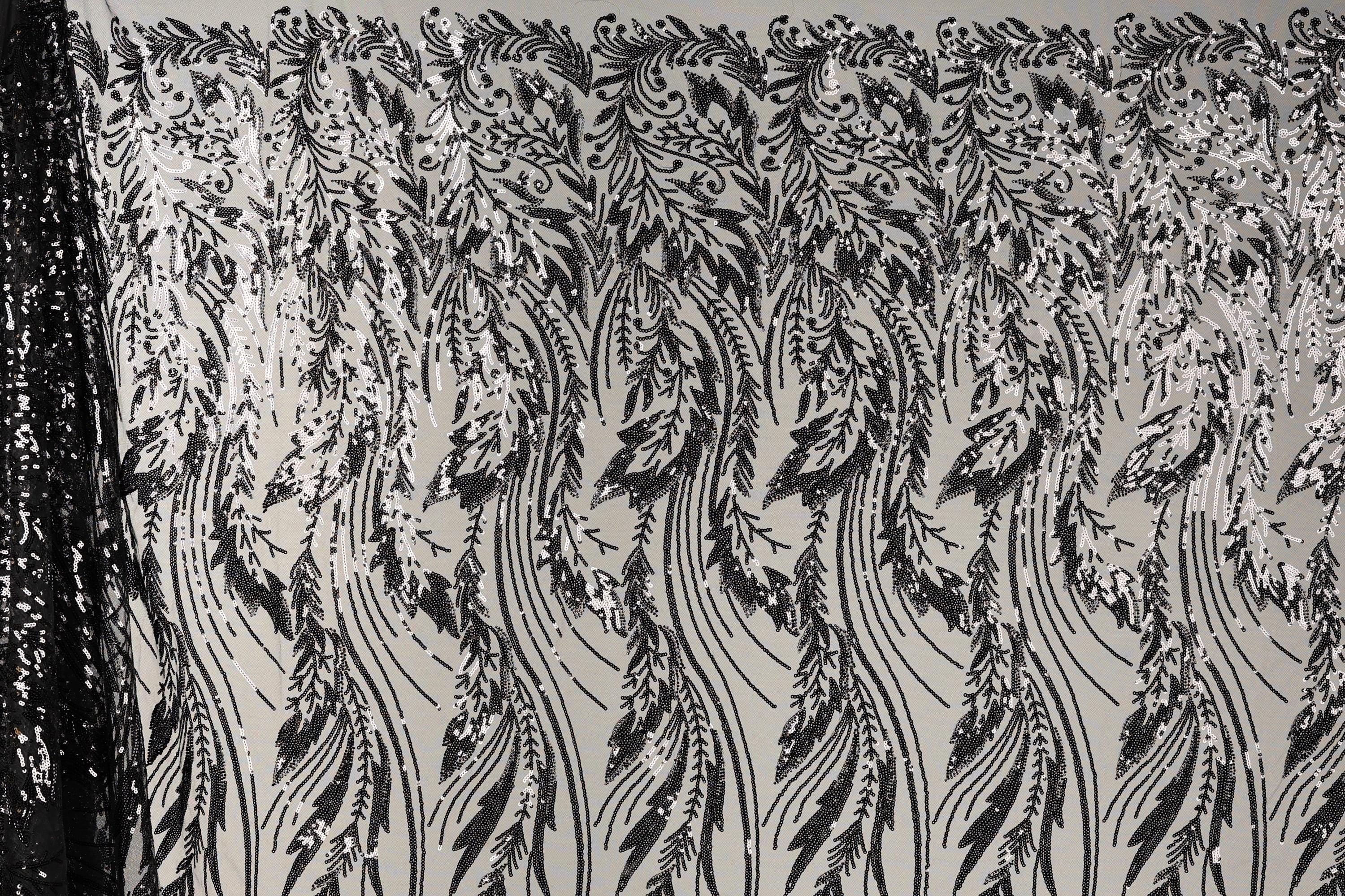 a close-up view of a black and white patterned fabric with a repeating floral design. The pattern consists of long, thin lines that create a sense of movement and rhythm across the fabric. The design is intricate and detailed, with each line contributing to the overall visual impact of the pattern.