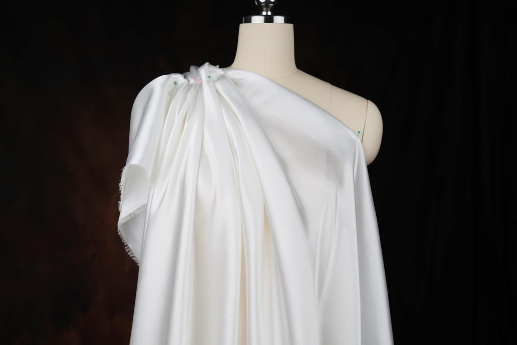 a white dress on a mannequin with a black background