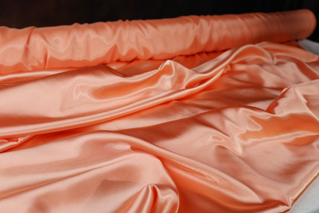 a close up of a pink satin material