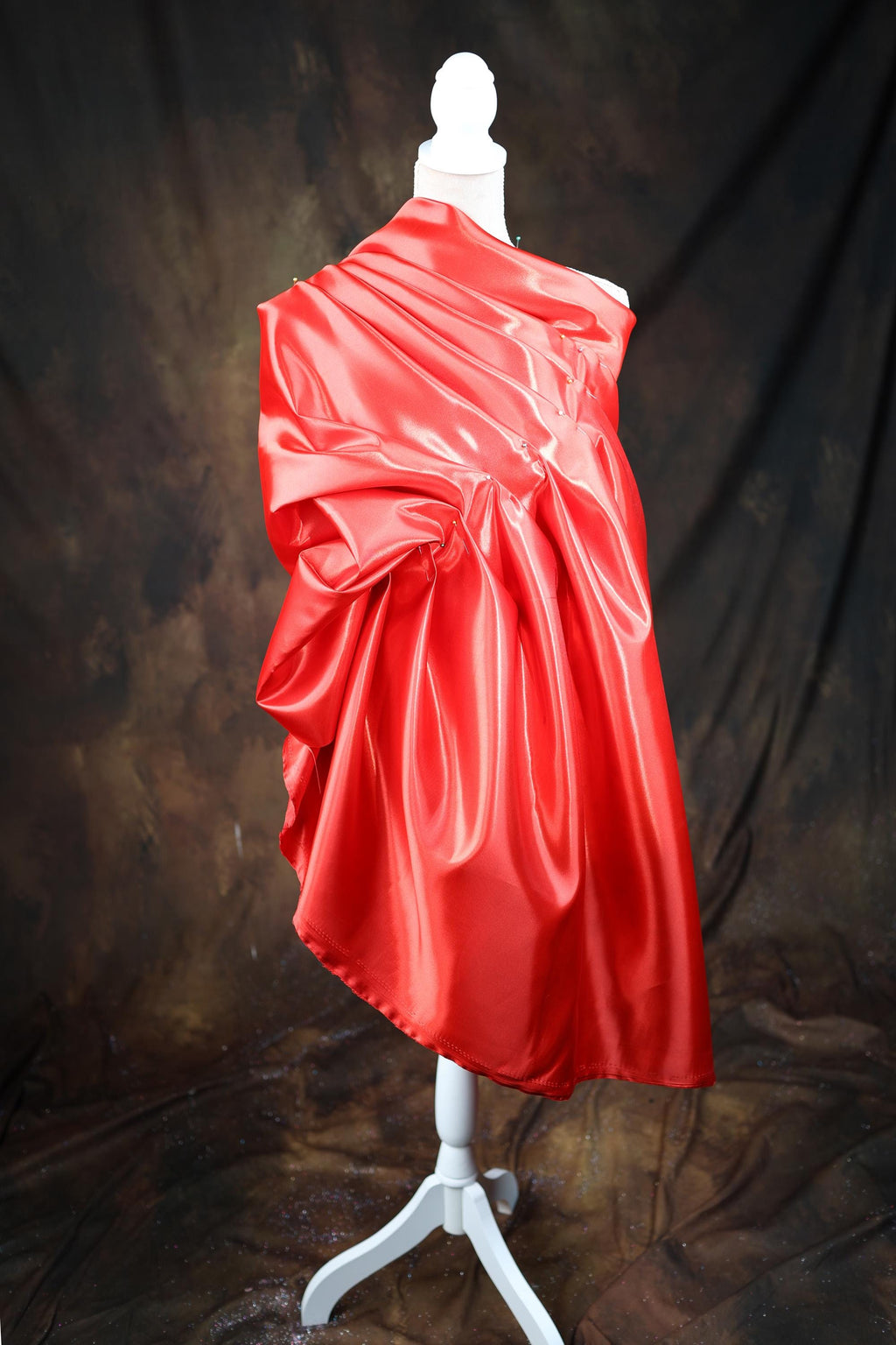 a red dress on a mannequin on a black background