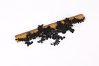 a piece of black lace or fabric with intricate floral patterns, placed on top of a wooden ruler.