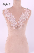 A mannequin with a pink floral lace overlay on its bust area, displayed against a light pink background.