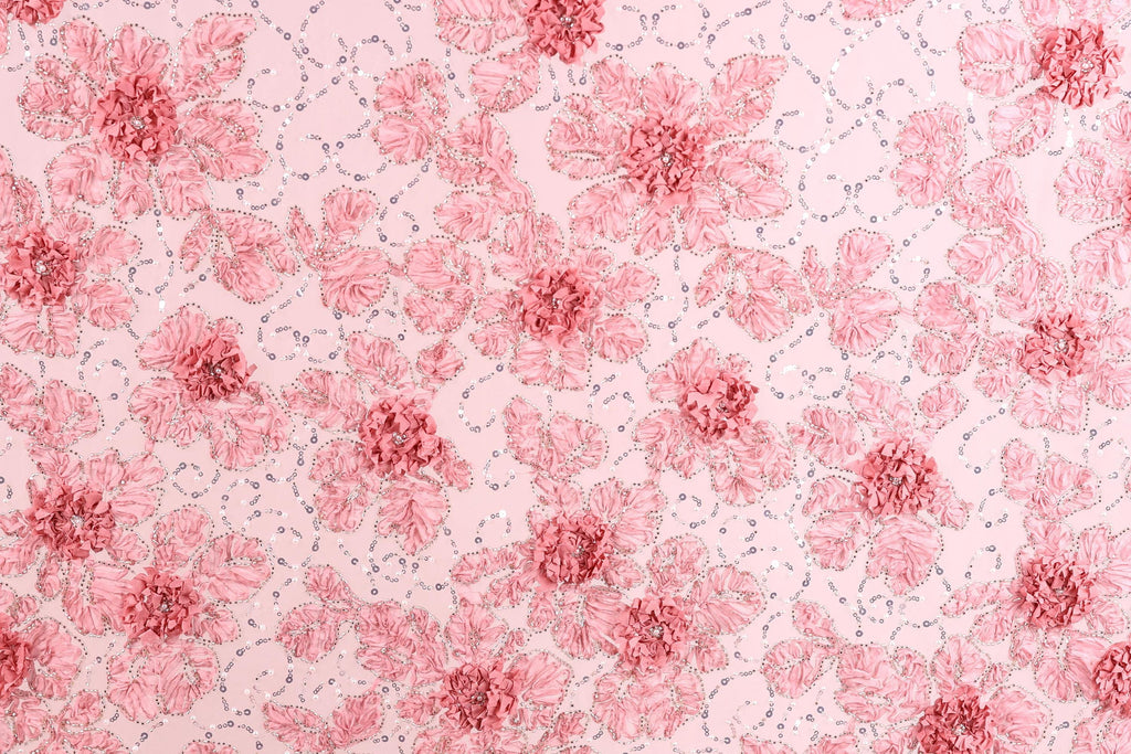 a repeating pattern of pink flowers with green leaves on a light pink background.