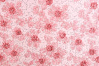 a repeating pattern of pink flowers with green leaves on a light pink background.