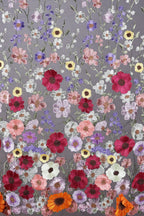 a vibrant and colorful floral pattern with a variety of flowers in shades of red, pink, white, and purple. The flowers are intricately embroidered and arranged in a visually appealing manner, creating a lively and dynamic composition.